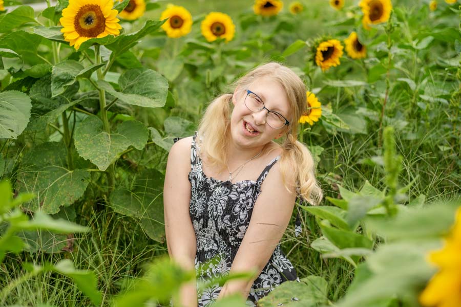 young girl in sunflower field